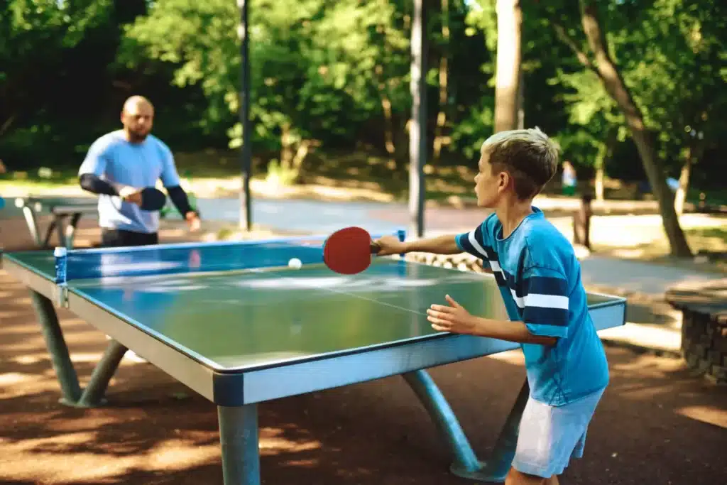 father and son playing ping pong scaled