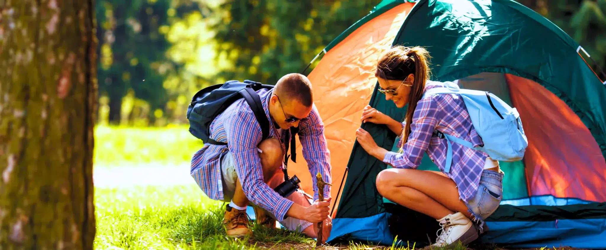 couple pitching a tent